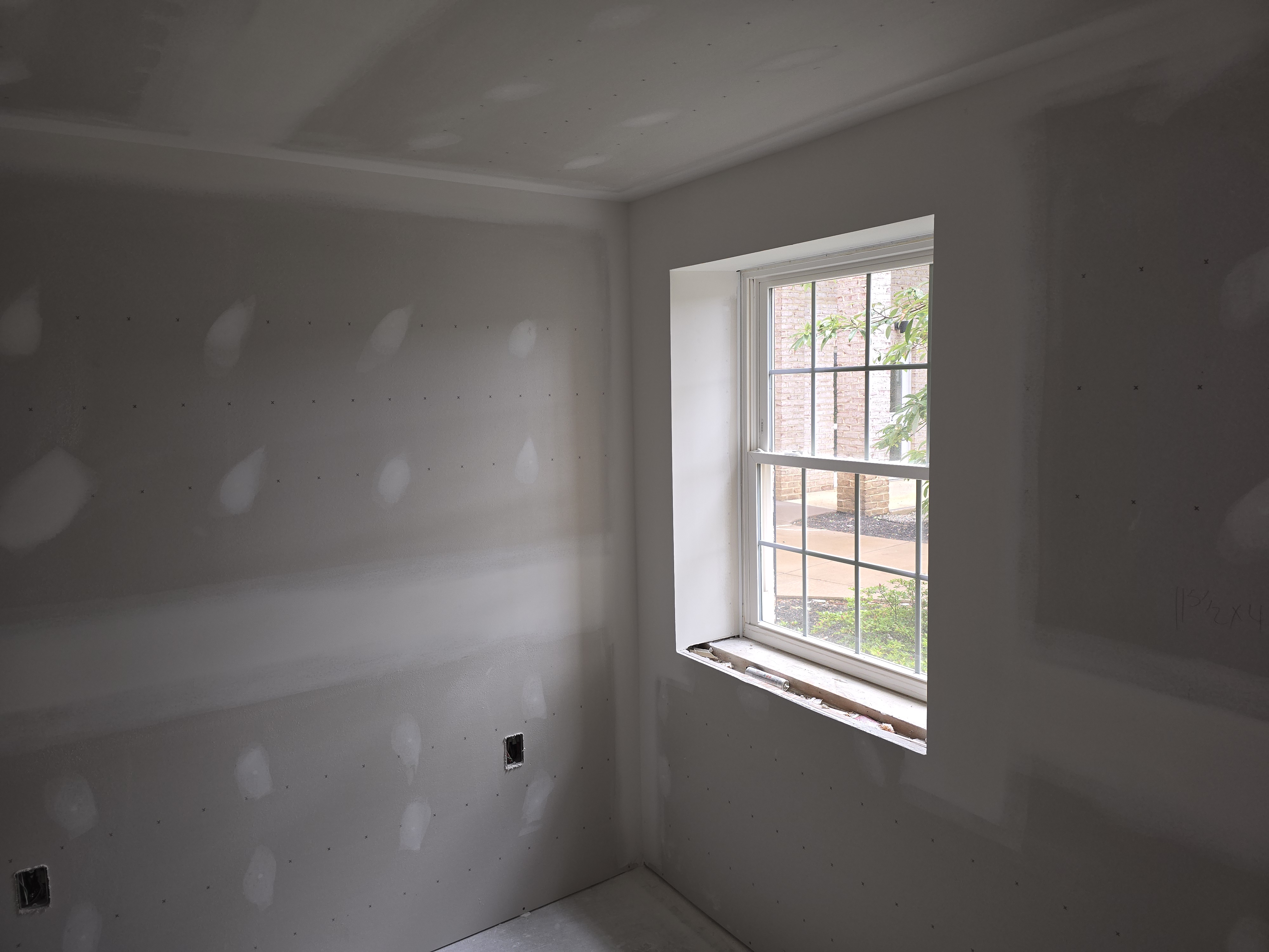 Finished drywall planes and window returns ready for paint